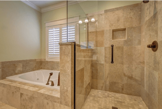 Renovated bathroom with a travertine-tiled tub surround and walk-in shower
