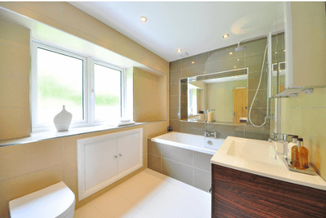 Bathroom with beige tiled shower surround, bathtub and vanity