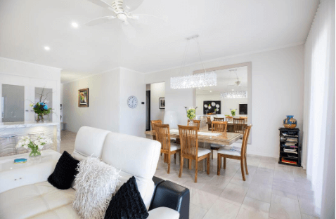 Open-plan living and dining area with light beige floor tiles