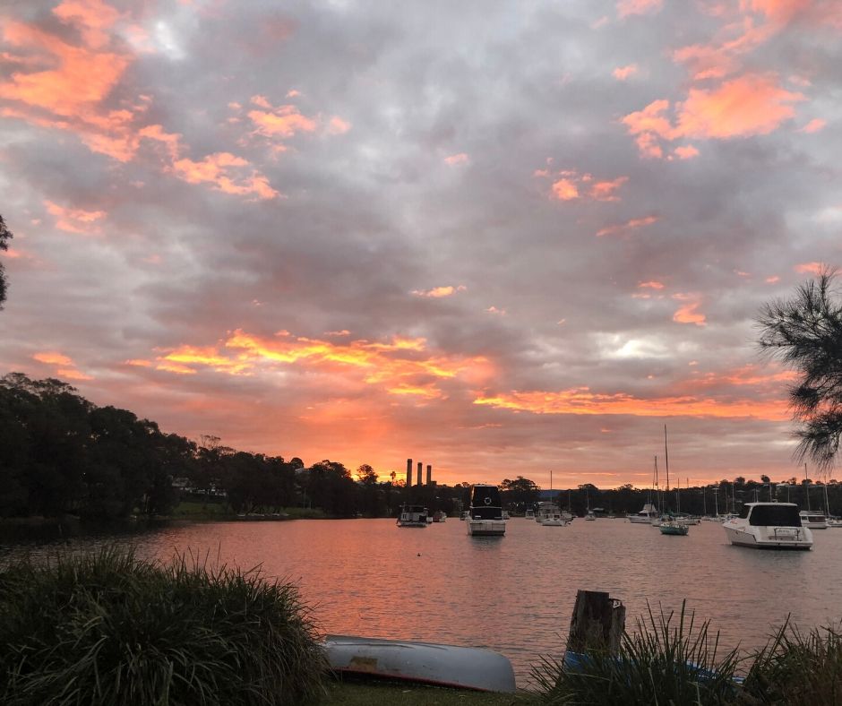 Orange sunset over boats moored on Lake Macquarie