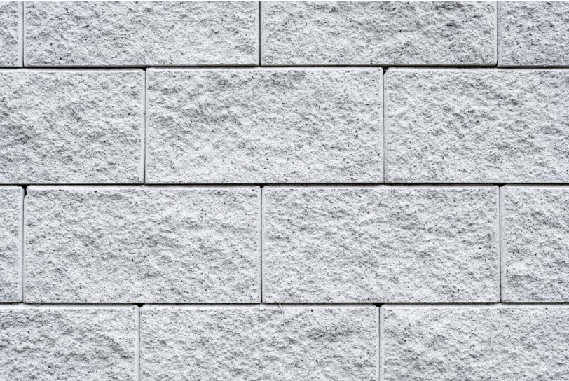 Close-up of textured grey stone-look tiles on an outdoor wall