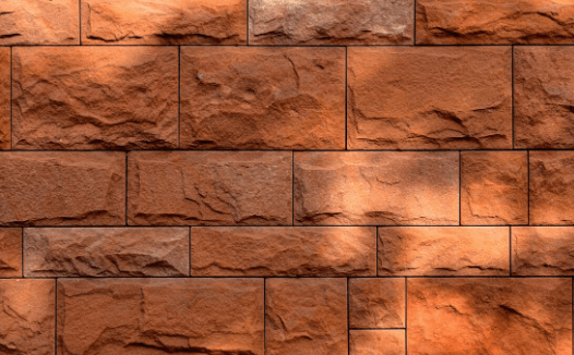 Textured terracotta stone tiles installed on an outdoor feature wall