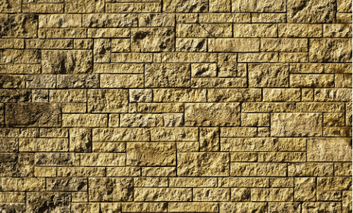 Split-face natural stone tiles installed on an outdoor feature wall