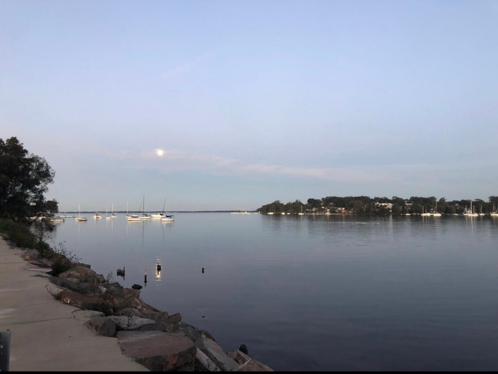 Sunset view over the water at Lake Macquarie with moored boats