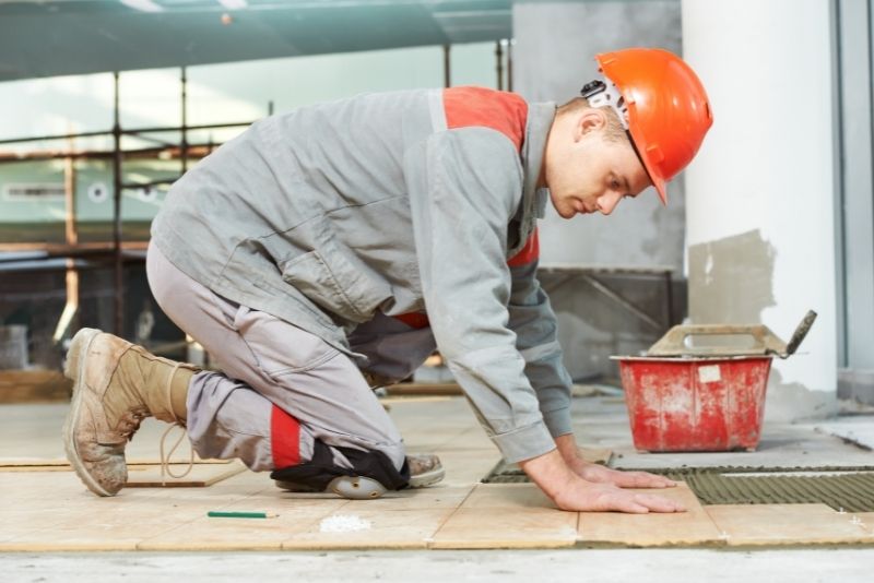 A tiler renovating floor tiles